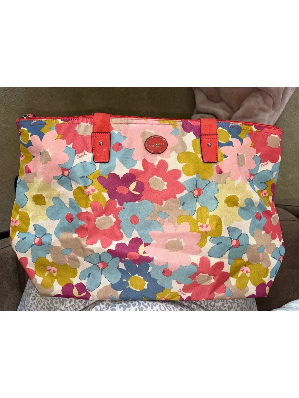 Bright and cheerful Coach tote featuring an oversized multicolor floral print.